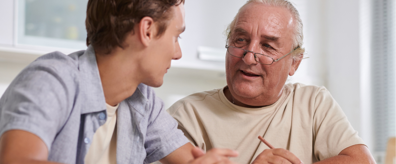 Man discussing reminiscence therapy benefits with caregiver