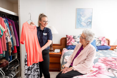 Aged care worker assists client at home
