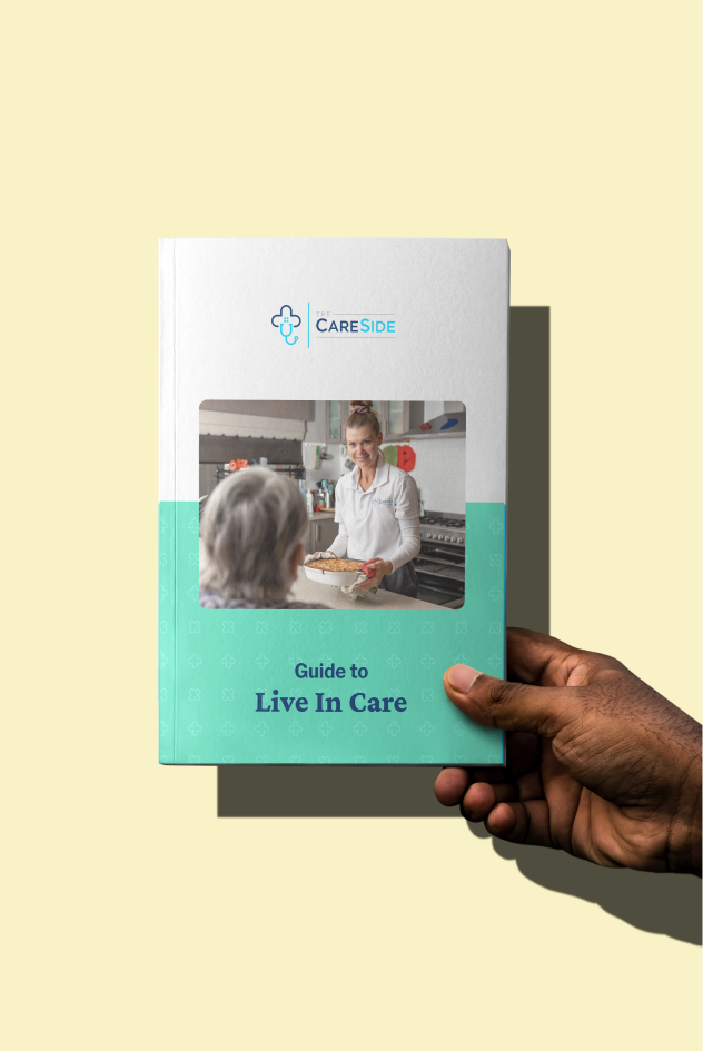 Hand holding The CareSide's guide to Live-In Care.