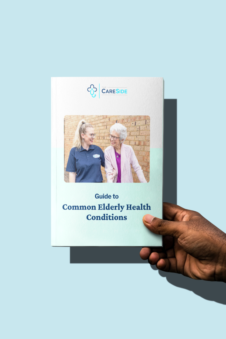 Hand holding The CareSide's guide to Common Elderly Health Conditions.