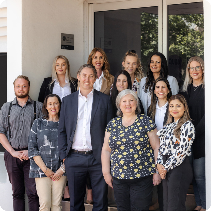 Members of The CareSide team gather outside and smile while posing for a photo.