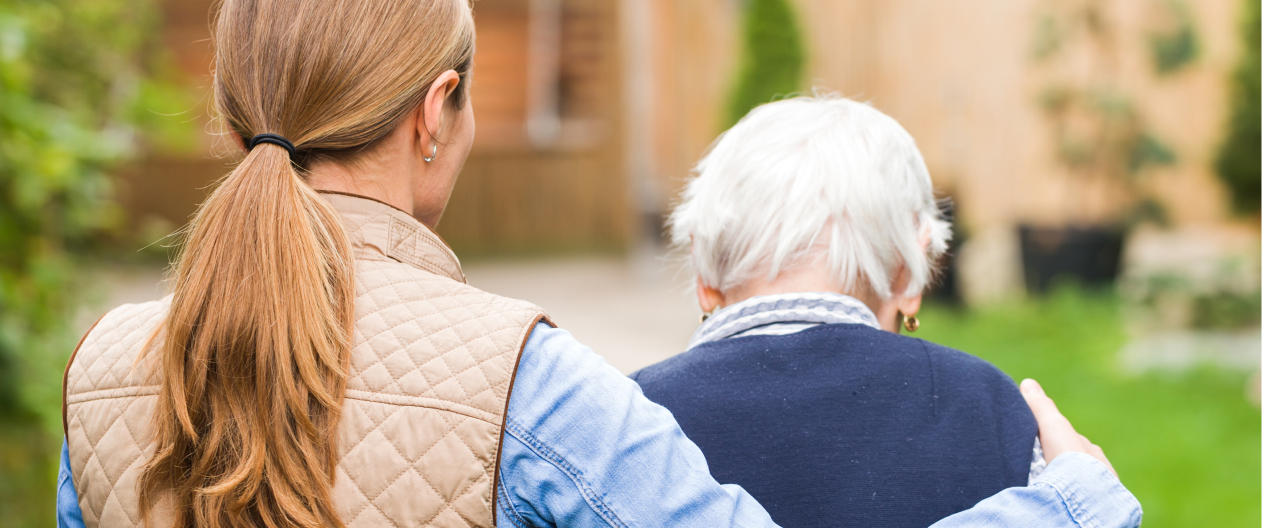 Woman walking with her mother who has Alzheimer's disease