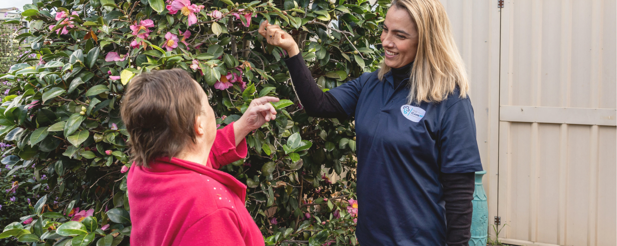 Support worker helping woman with Down syndrome