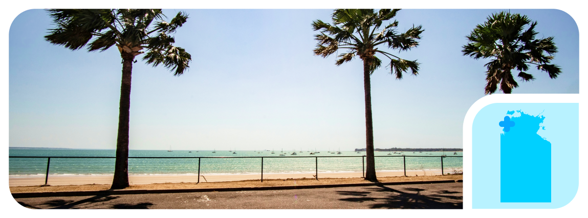 Trees sway in the breeze near a beach in Darwin, where The CareSide provides the best home care in NT.