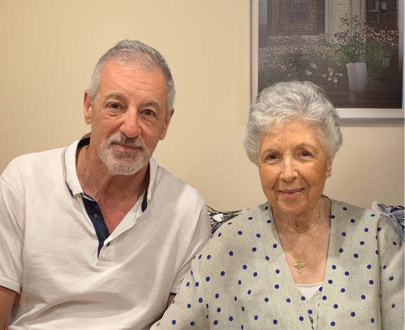 Carla and her son, Sam, smile for a photo while discussing The CareSide's reliable home care, precise care times, and same caregiver every time.