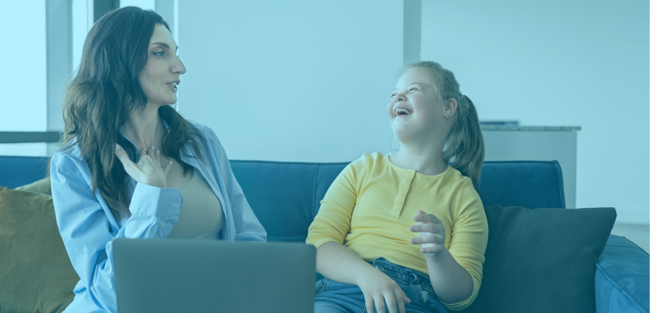 A young girl laughs while working with her instructor as part of her NDIS Improved Learning supports.