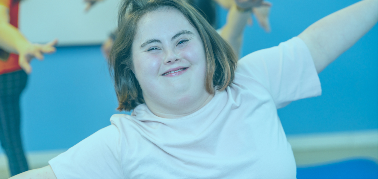 A young girl smiles while exercising and leveraging the Improved Health and Wellbeing category of her NDIS plan.