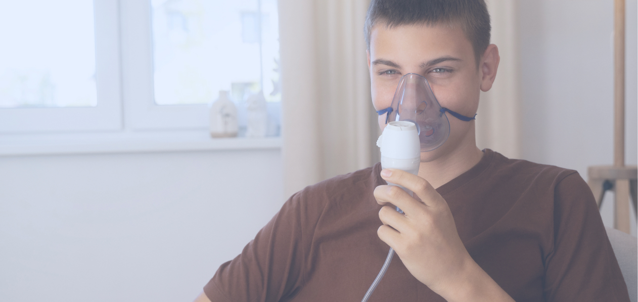 A boy uses a machine for respiratory support secured under the NDIS consumables budget.