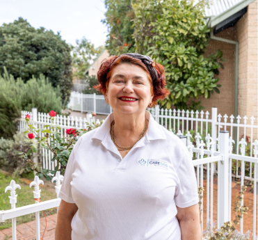 An aged care professional from The CareSide smiles and poses for a photo.