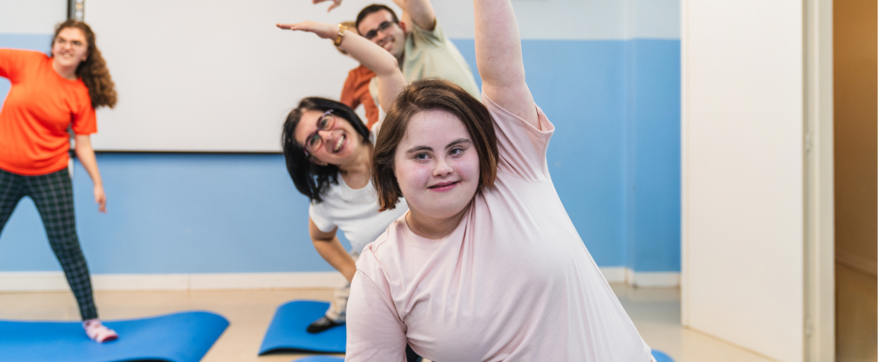 A girl enjoys an exercise class as part of her NDIS Core Support: Assistance with Social, Economic and Community Participation plan.