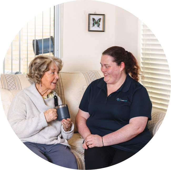 A friendly caregiver from The CareSide smiles and chats with her client while providing home care services in Perth.