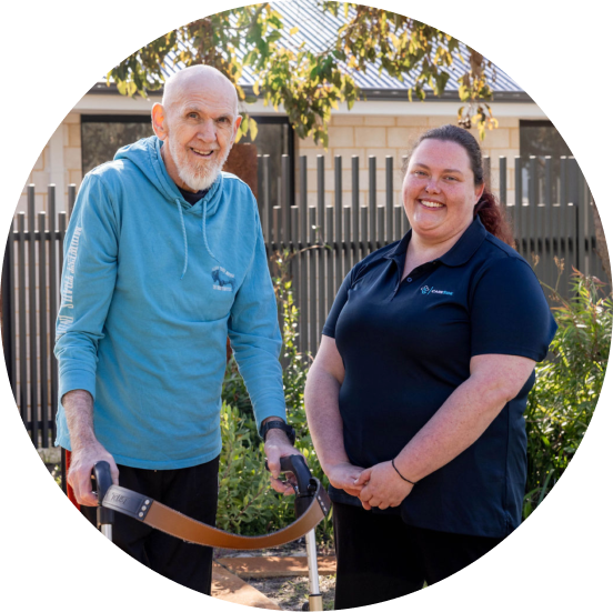 A caregiver from The CareSide providing respite care services while standing next to her happy client.