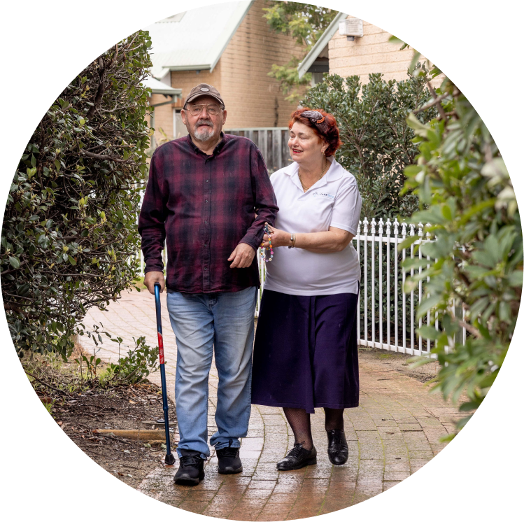 A home care recipient enjoys a walk with his caregiver from The CareSide.