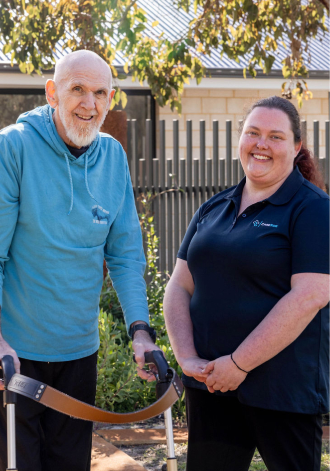 Central Coast home care recipient smiles and poses for a photo alongside his caregiver from The CareSide.