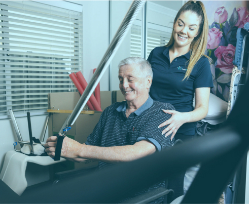 A professional from The CareSide provides post-hospital support while helping her home care client complete his rehabilitation exercises.